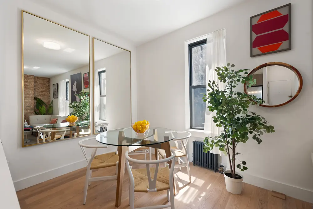 80 Charles Street, Residence 3R: the dining corner, staged against a full mirrored wall to widen the room