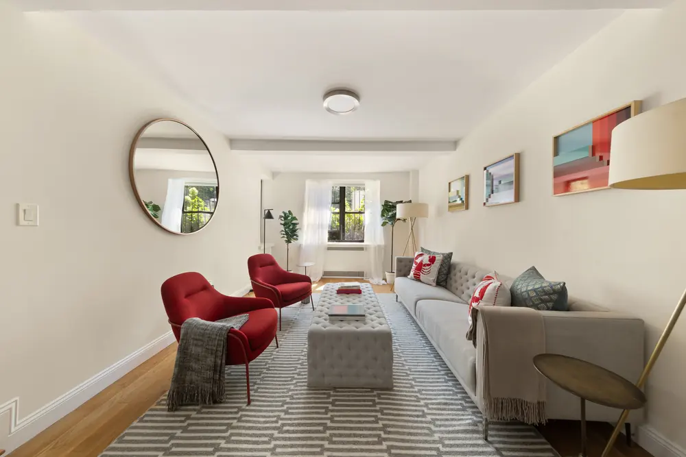 425 Central Park West, Residence 1D: the living room seen the other way, with a round mirror above the sofa