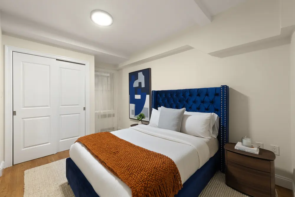 425 Central Park West, Residence 1D: the same bedroom showing the closet wall and bedside styling
