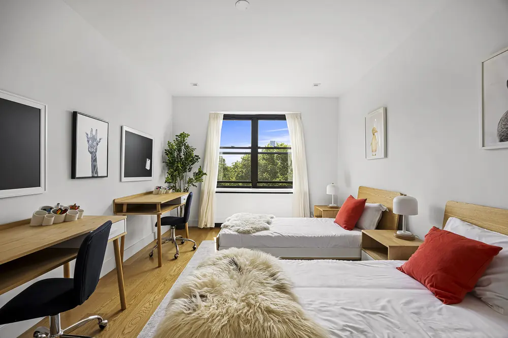 425 Central Park West, Residence 7CD: a second bedroom staged with twin beds and a shared desk wall