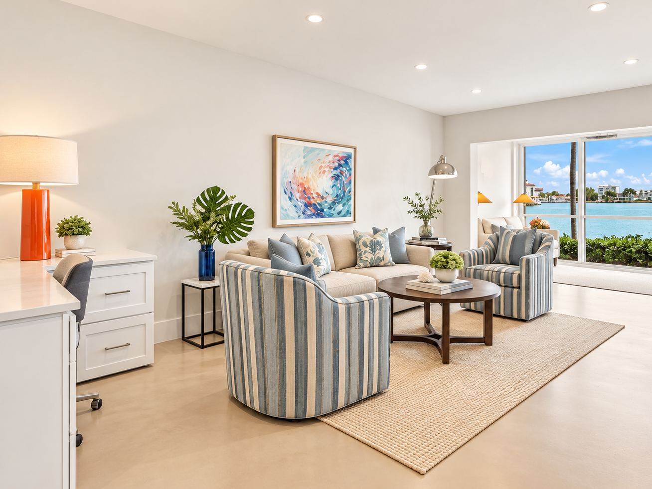 An open living area with striped swivel chairs and a view of the bay.